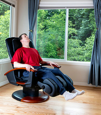 men relaxing on massage chair at high end luxury barbershop